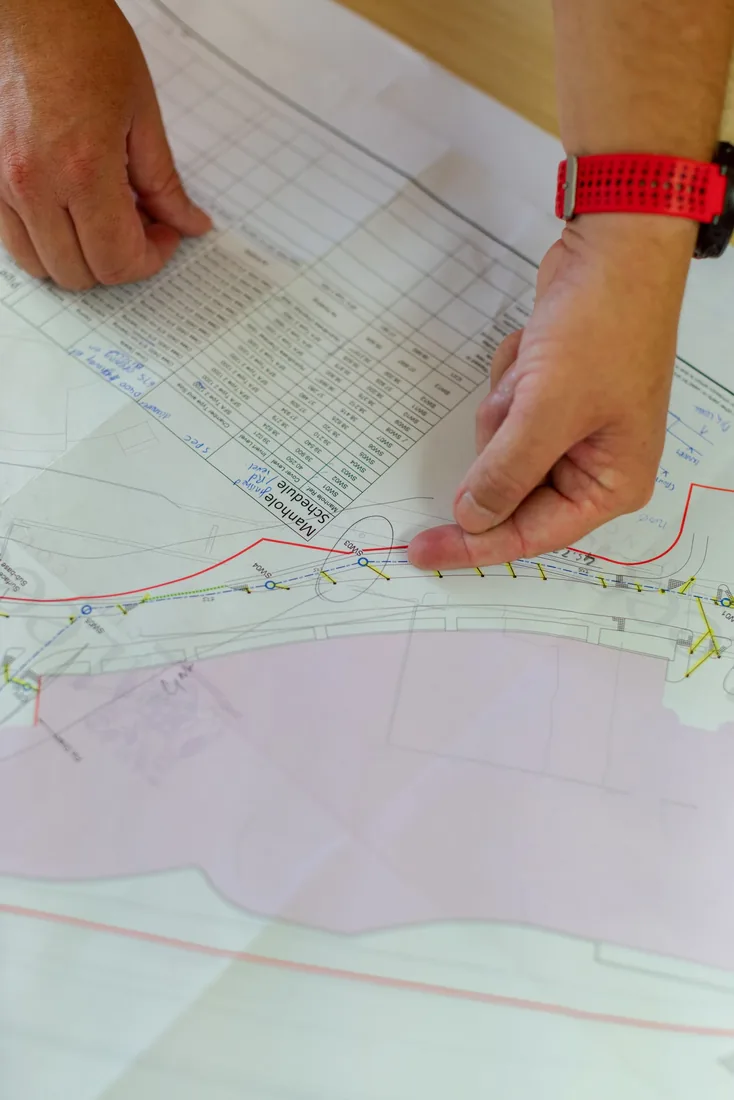Engineers reviewing a detailed construction plan
