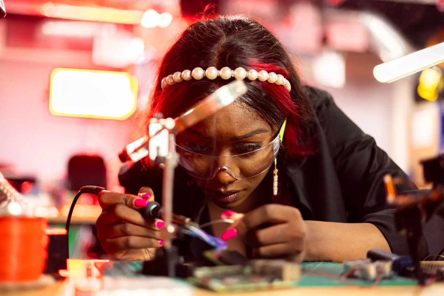 Engineer soldering electronic components at a workbench