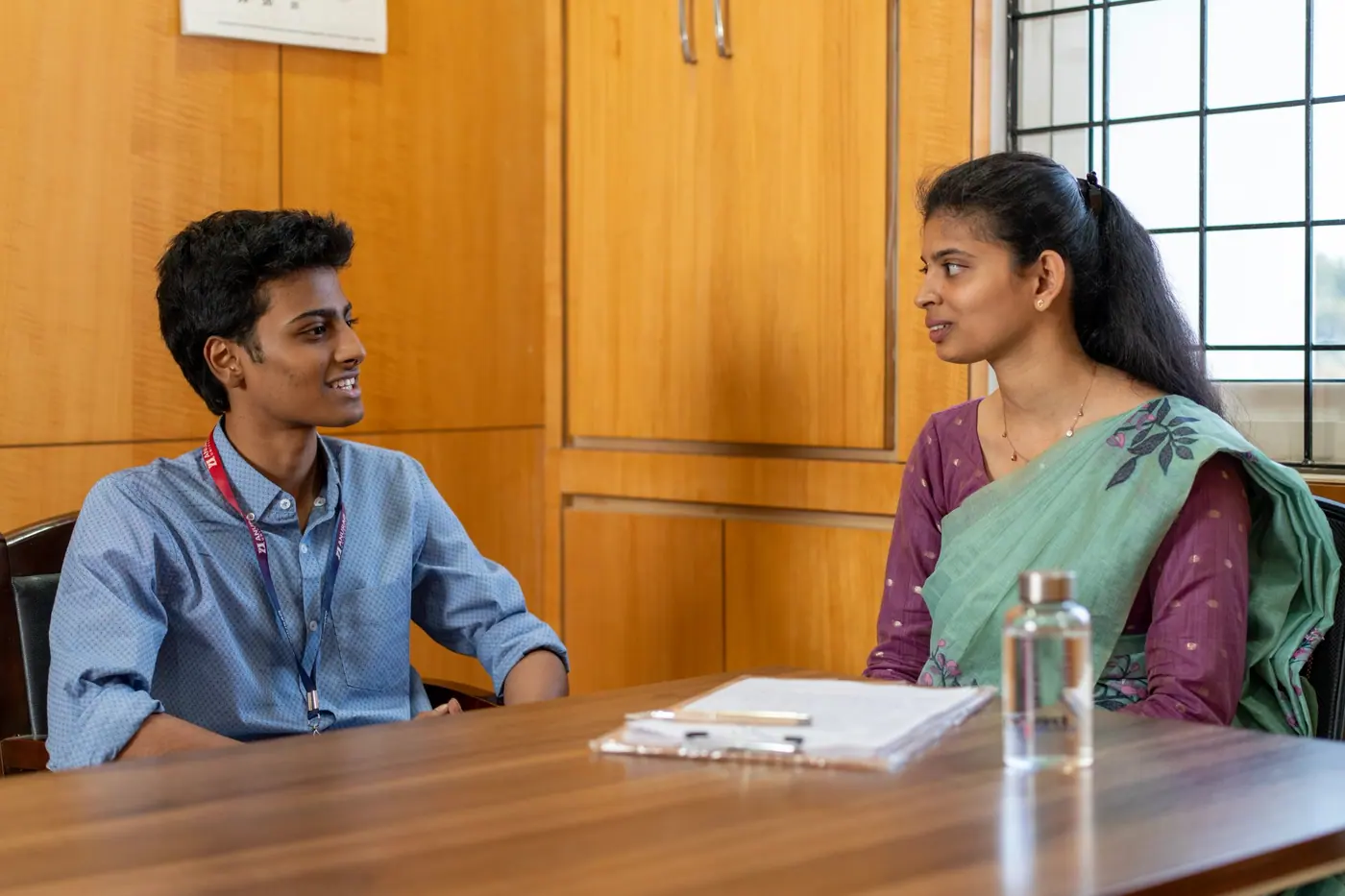 A student in a one-to-one interview with a faculty member