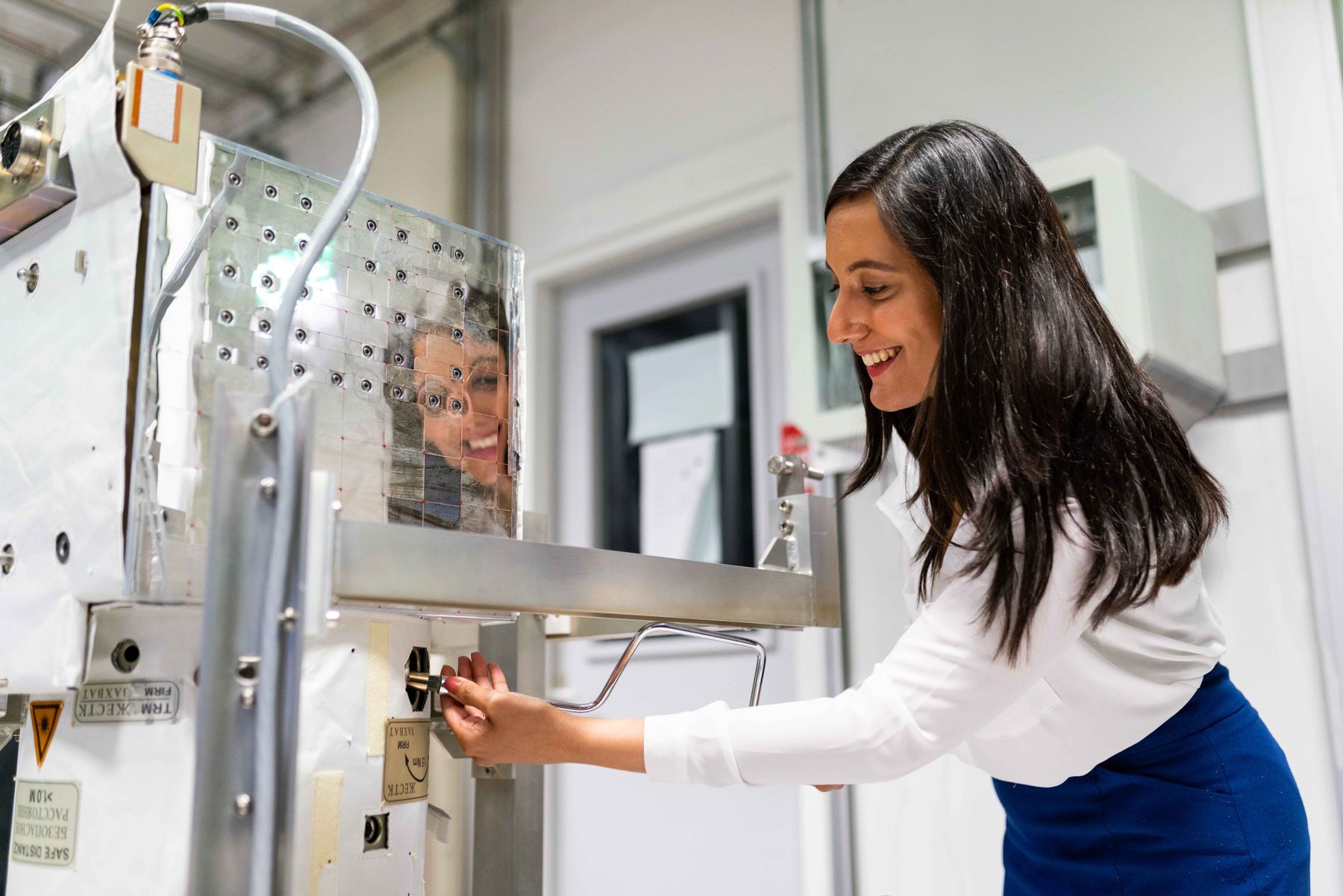 An engineer adjusting industrial equipment in a laboratory