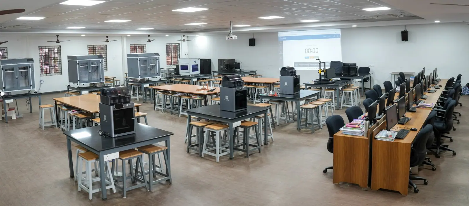A computer lab with rows of workstations