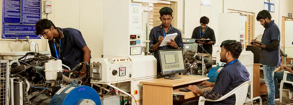 Students operating machines in an engineering innovation lab