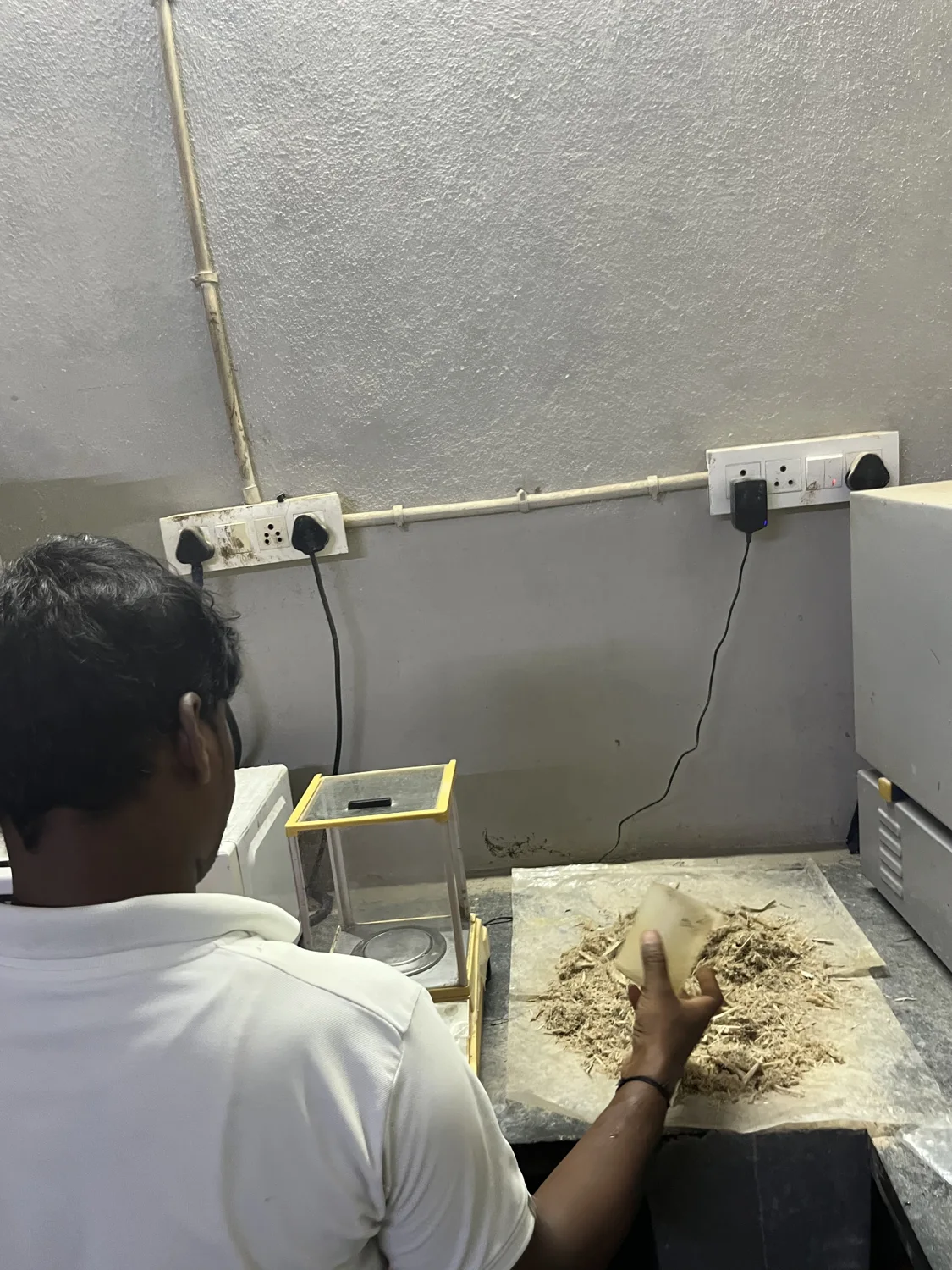 A worker handling growing material at a preparation table