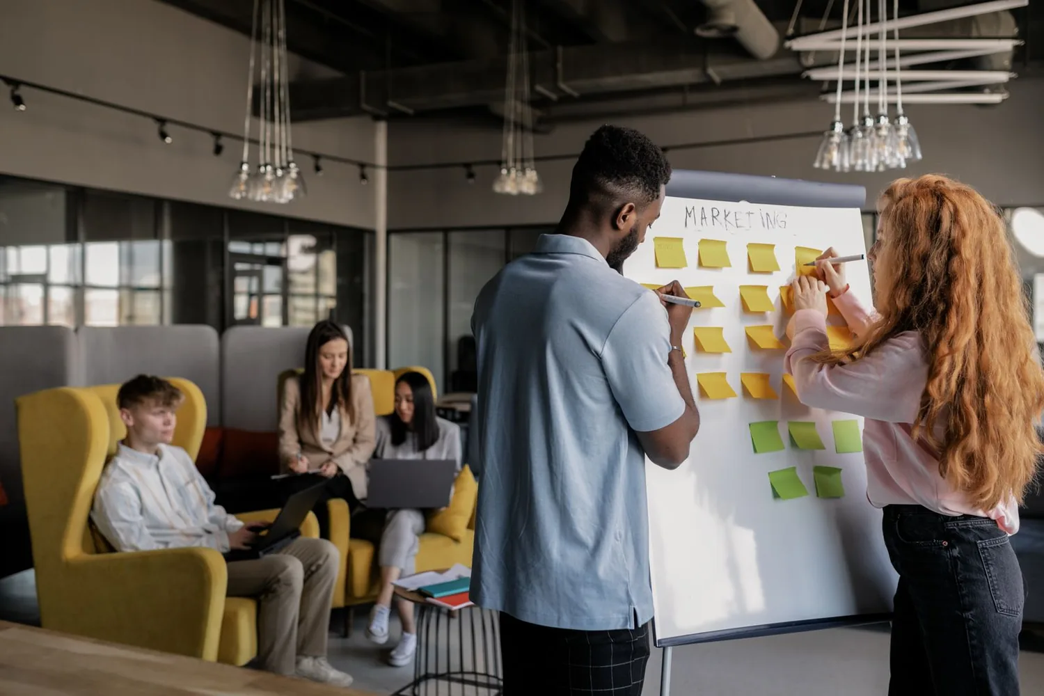 Team arranging ideas on a whiteboard during a planning session