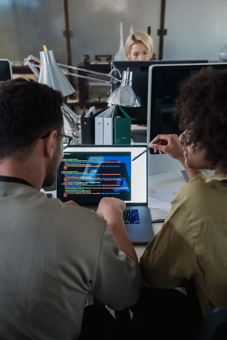 Illustrative software team collaborating at a computer